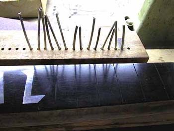 54_preparing_frets_to_insert_them_into_the_fingerboards